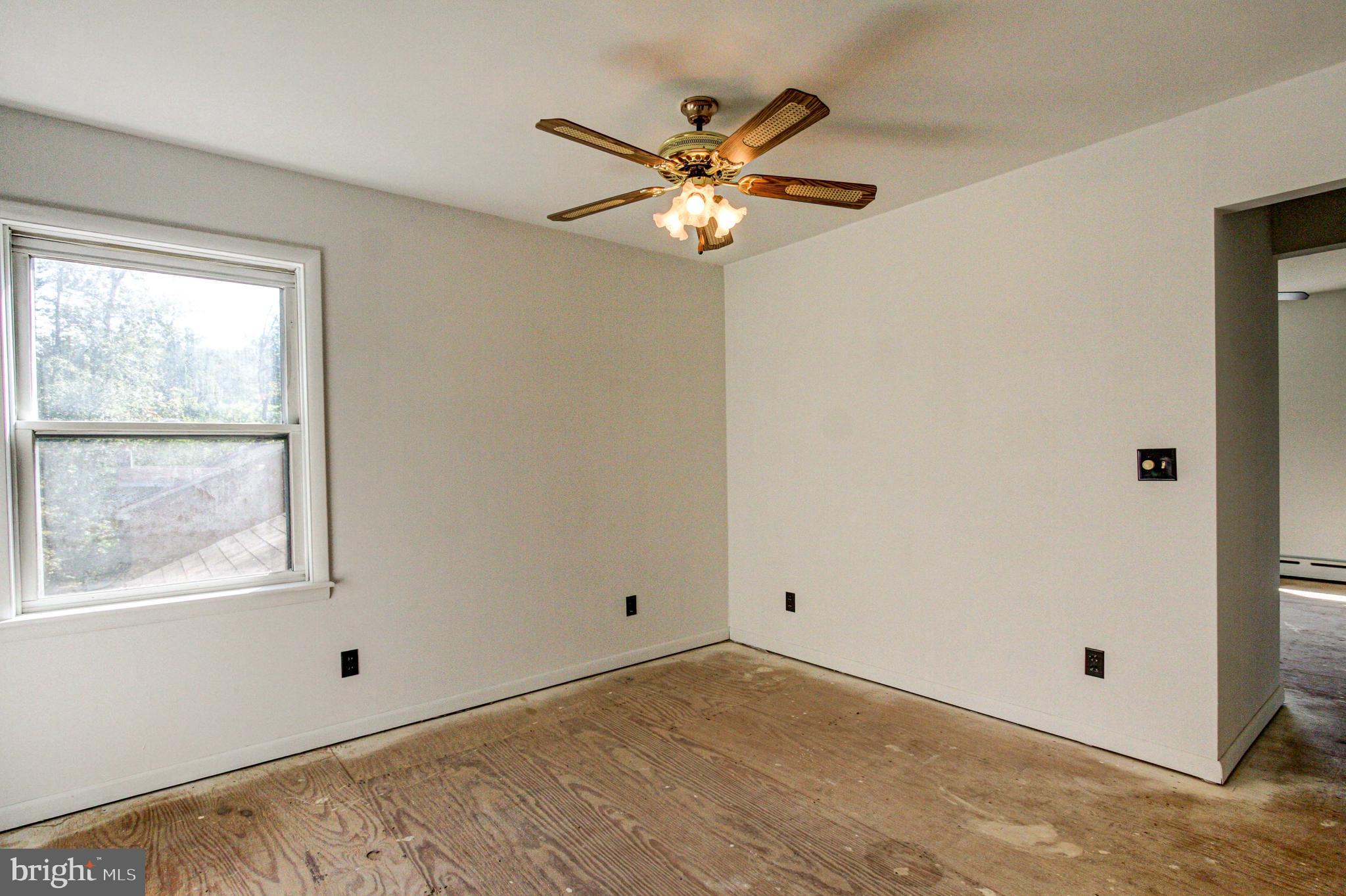 2030 Upper Ridge Road Green Lane, PA 18054 - Photo 36 of 61 a view of wooden floor and a chandelier fan in a room