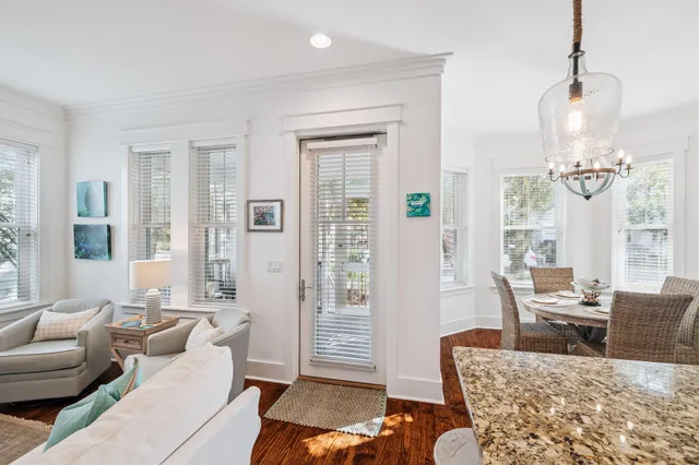 a living room with furniture ceiling fan and a wooden floor
