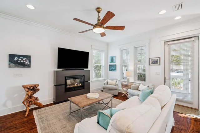 a living room with furniture a fireplace and a flat screen tv
