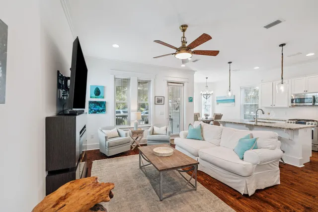 a kitchen with stainless steel appliances granite countertop a table chairs stove and refrigerator