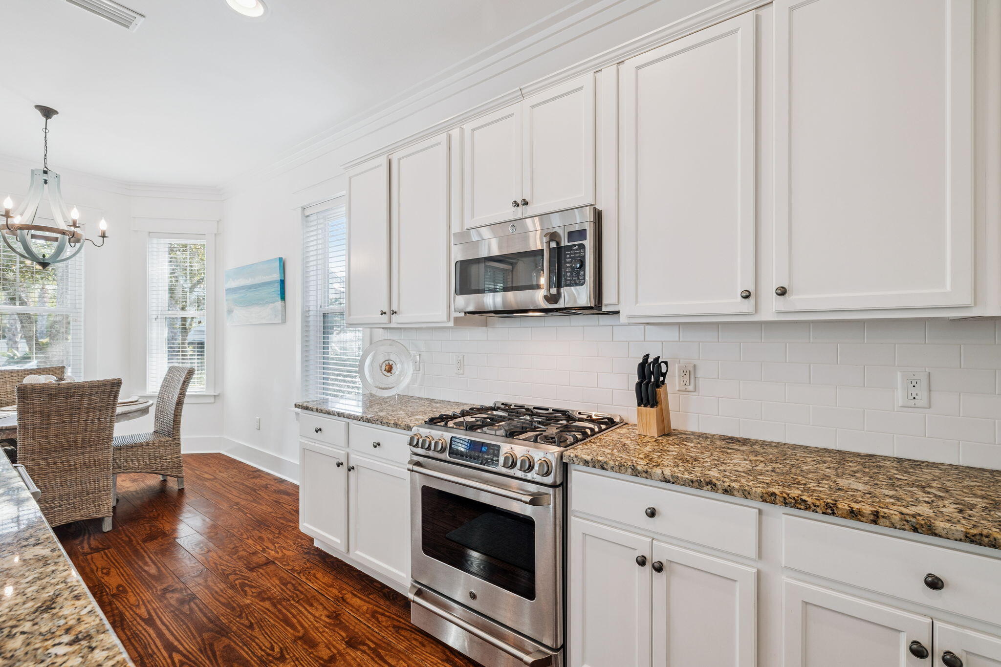 844 Sandgrass Boulevard Santa Rosa Beach, FL 32459 - Photo 18 of 74 a kitchen with granite countertop white cabinets and stainless steel appliances