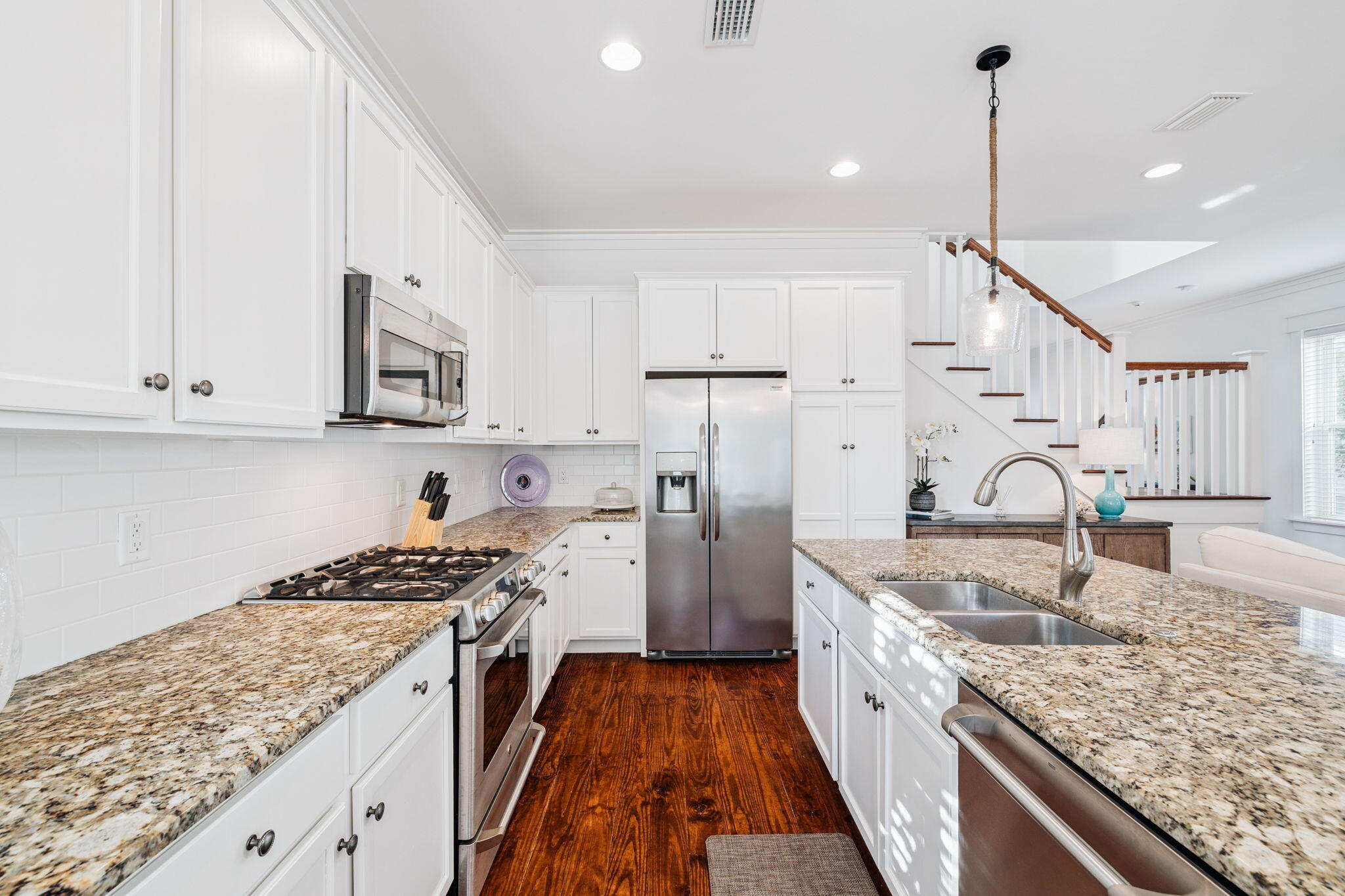 844 Sandgrass Boulevard Santa Rosa Beach, FL 32459 - Photo 20 of 74 a kitchen with stainless steel appliances granite countertop a stove top oven a sink dishwasher and cabinets with wooden floor