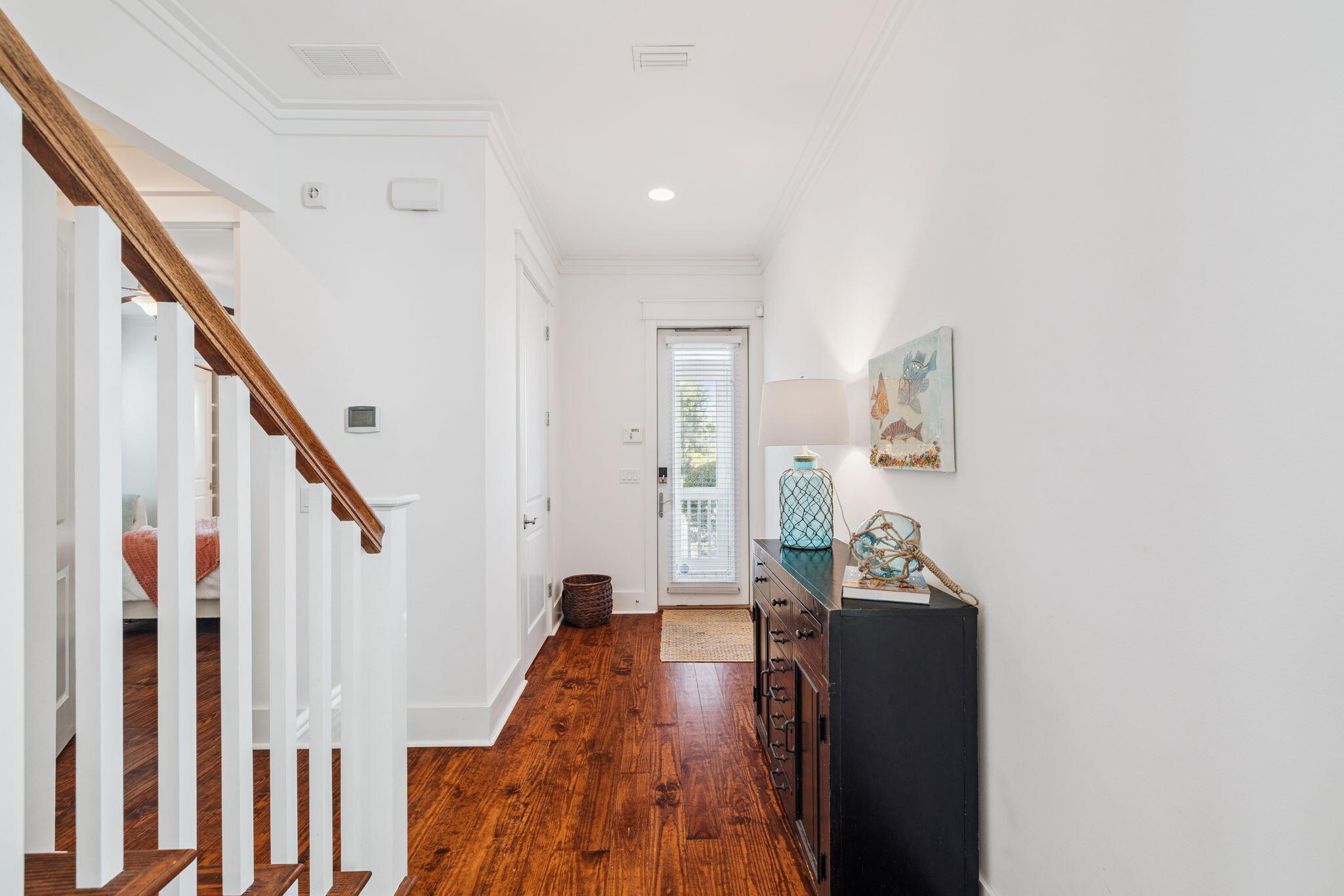 844 Sandgrass Boulevard Santa Rosa Beach, FL 32459 - Photo 23 of 74 a view of a hallway with wooden floor and staircase