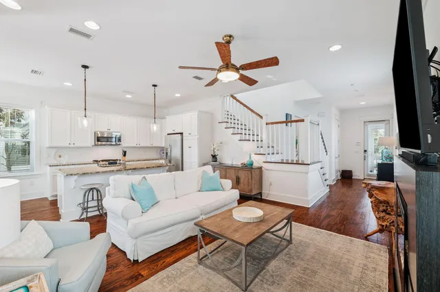 a kitchen with granite countertop white cabinets and stainless steel appliances