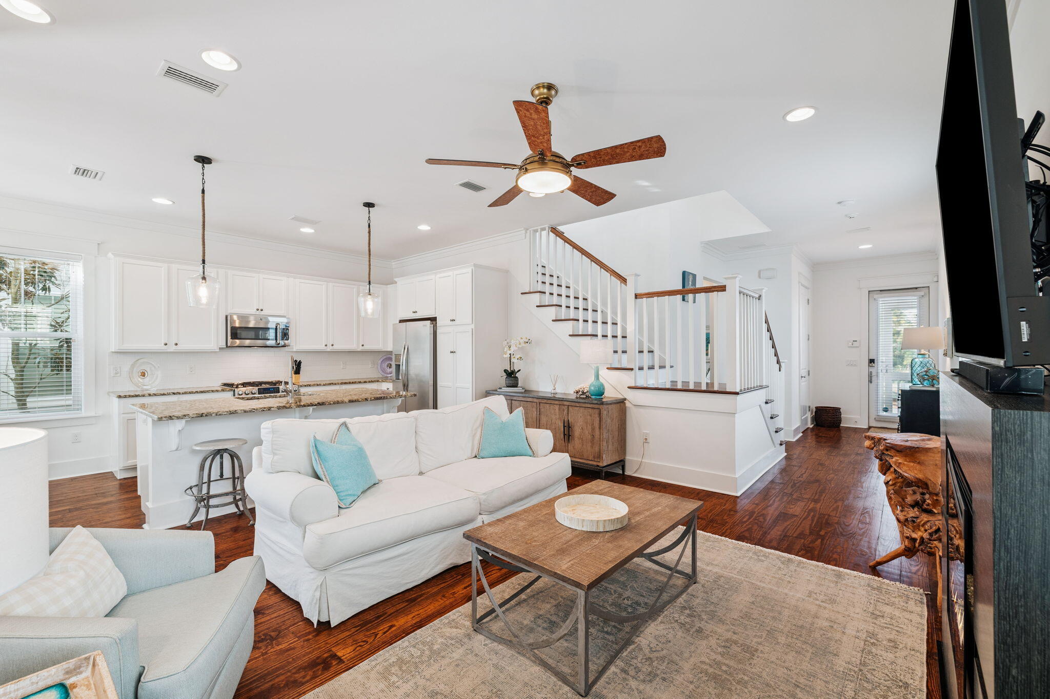 844 Sandgrass Boulevard Santa Rosa Beach, FL 32459 - Photo 6 of 74 a living room with furniture kitchen view and a chandelier