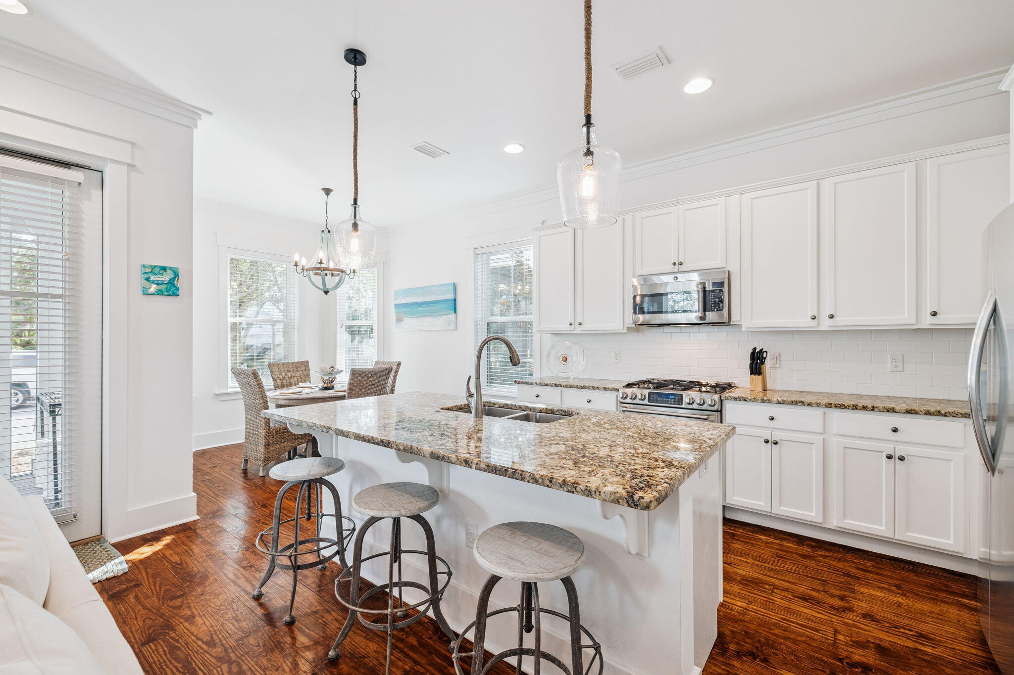 844 Sandgrass Boulevard Santa Rosa Beach, FL 32459 - Photo 7 of 74 a kitchen with granite countertop white cabinets and stainless steel appliances