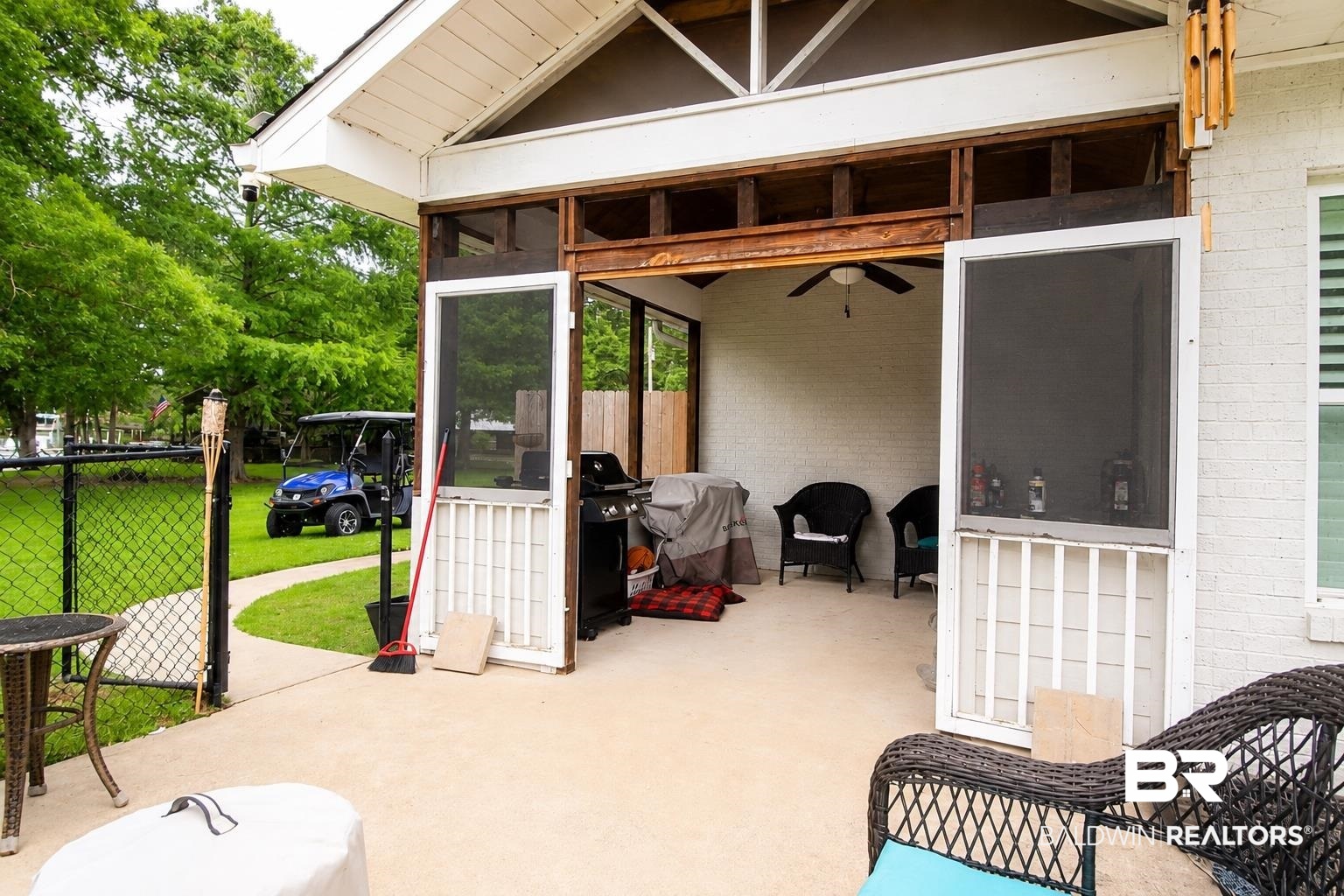 9825 Wolf Creek Ridge Elberta, AL 36530 - Photo 48 of 76 Covered patio area featuring a concrete slab, screened entry, exposed wood-finish ceiling, and a ceiling fan