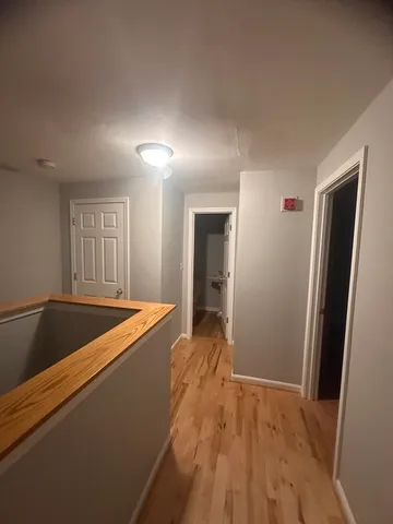 a view of an empty room and wooden floor