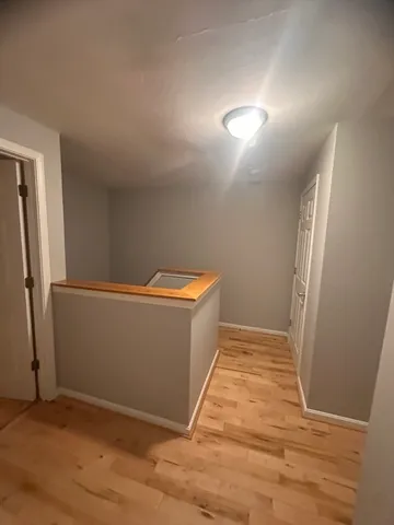 a view of room with window and wooden floor