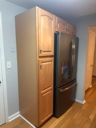a kitchen with metallic refrigerator freezer and a dishwasher