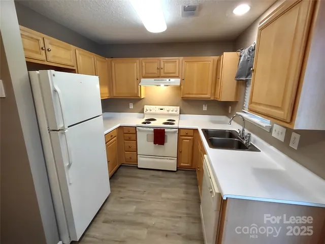 a white refrigerator freezer sitting inside of a kitchen