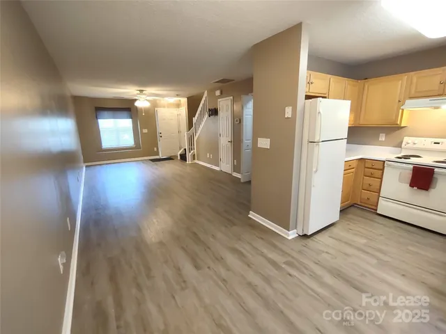a view of kitchen with furniture and wooden floor