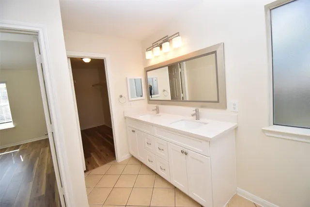 a bathroom with a sink a mirror and a shower