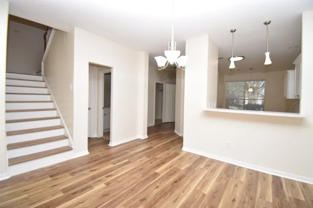 a view of a room with wooden floor and window