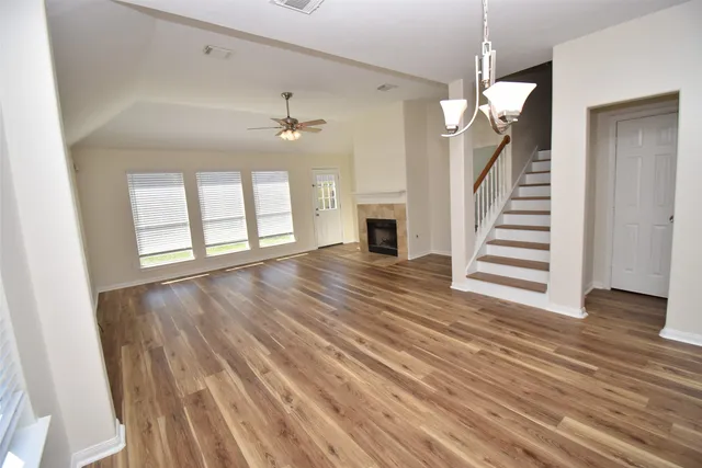 wooden floor in an empty room with a fireplace