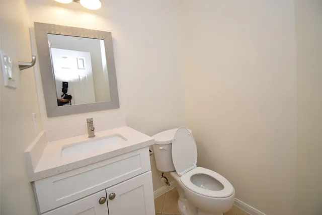 a white toilet sitting next to a bathroom sink
