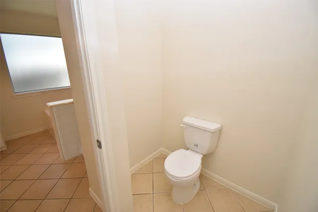 a white toilet sitting next to a shower