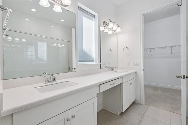 a bathroom with a sink double vanity and a mirror