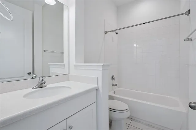 a bathroom with a sink toilet vanity and shower