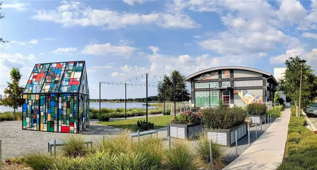 a view of a house with swimming pool and sitting area