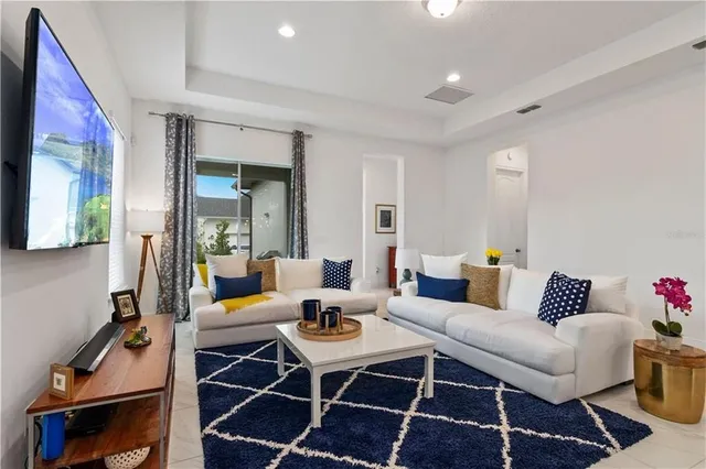 a living room with furniture and wooden floor