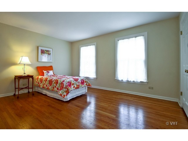1742 Appleby Road Inverness, IL 60067 - Photo 15 of 25 a bedroom with a bed and wooden floor