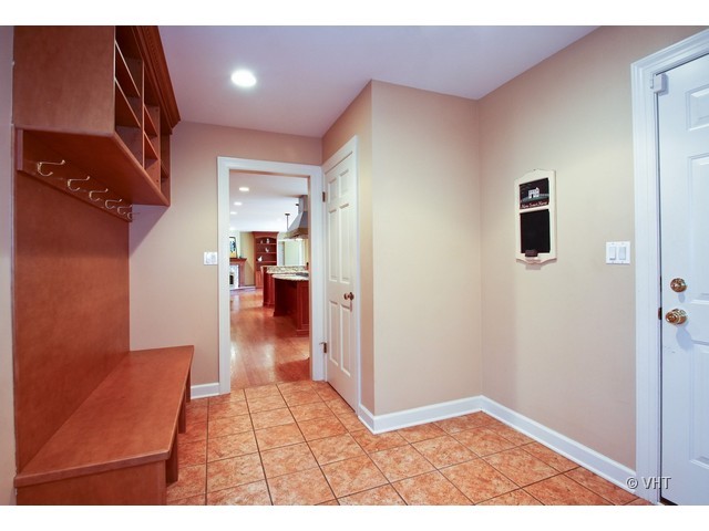 1742 Appleby Road Inverness, IL 60067 - Photo 19 of 25 a view of a hallway with wooden floor and a living room