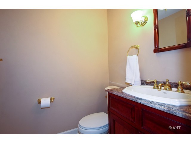 1742 Appleby Road Inverness, IL 60067 - Photo 21 of 25 a bathroom with a granite countertop sink and a mirror