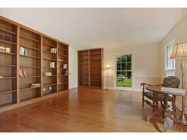 1742 Appleby Road Inverness, IL 60067 - Photo 9 of 25 a view of empty room with wooden floor and windows