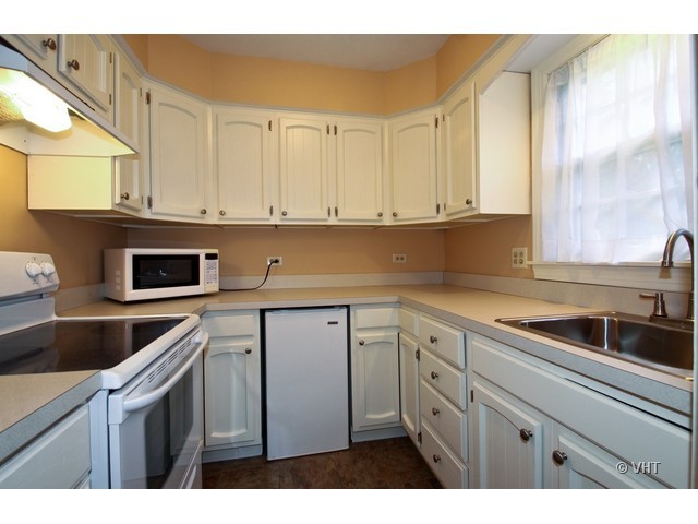 1742 Appleby Road Inverness, IL 60067 - Photo 10 of 25 a kitchen with stainless steel appliances granite countertop a sink and dishwasher next to a window