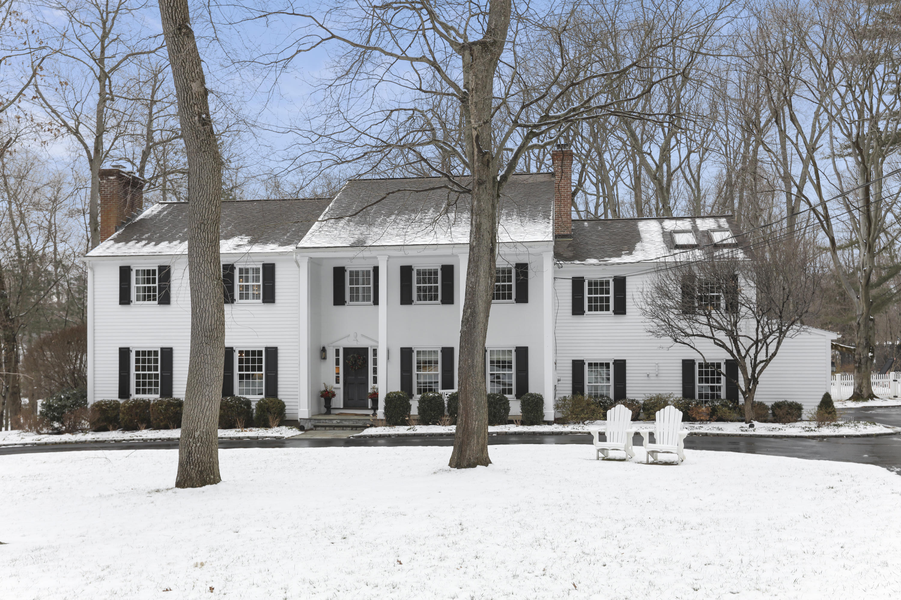 27 Deepwood Road Darien, CT 06820 - Photo 1 of 48 a view of a building with snow on the road