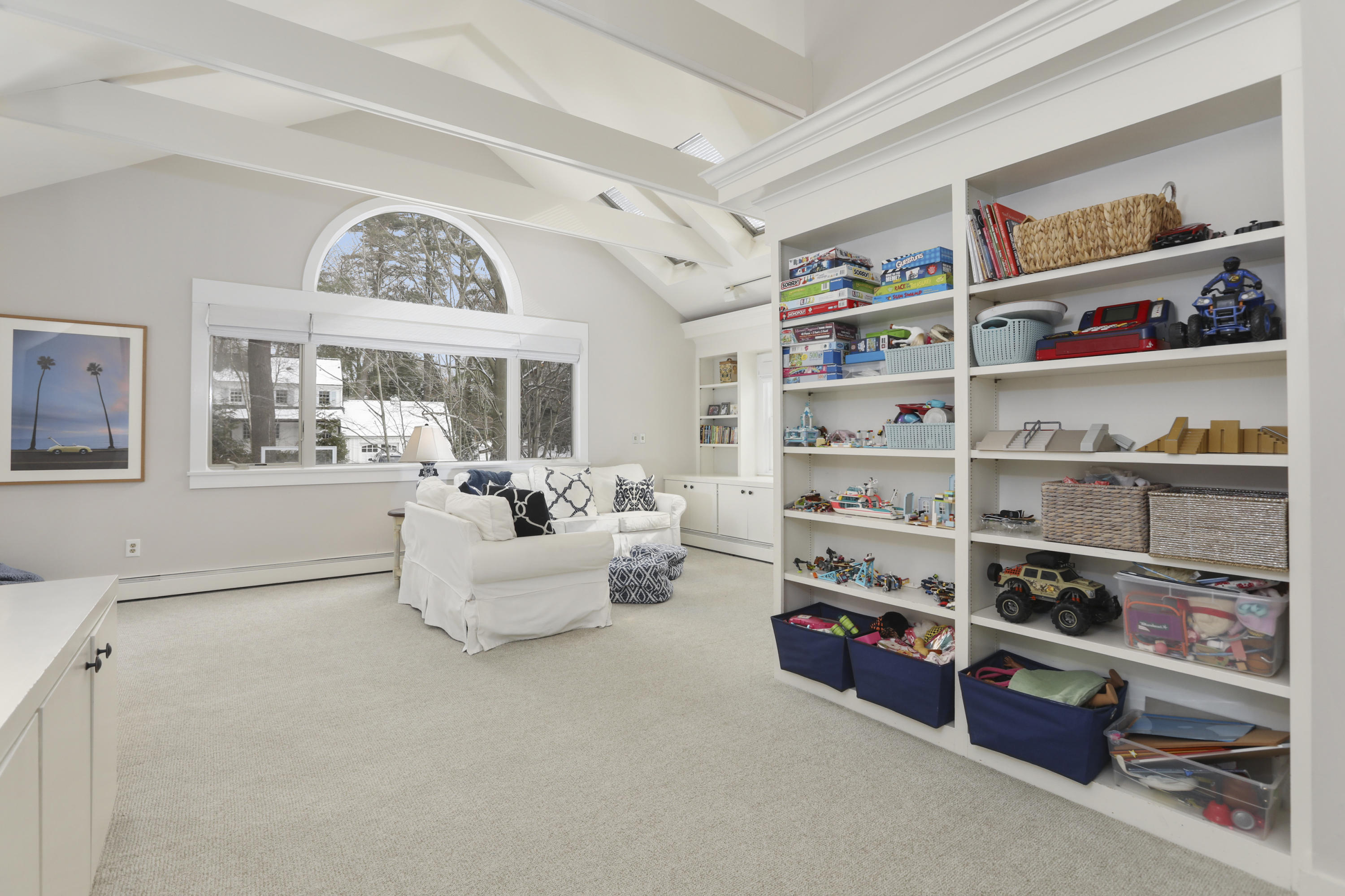 27 Deepwood Road Darien, CT 06820 - Photo 29 of 48 a living room with furniture and a book shelf