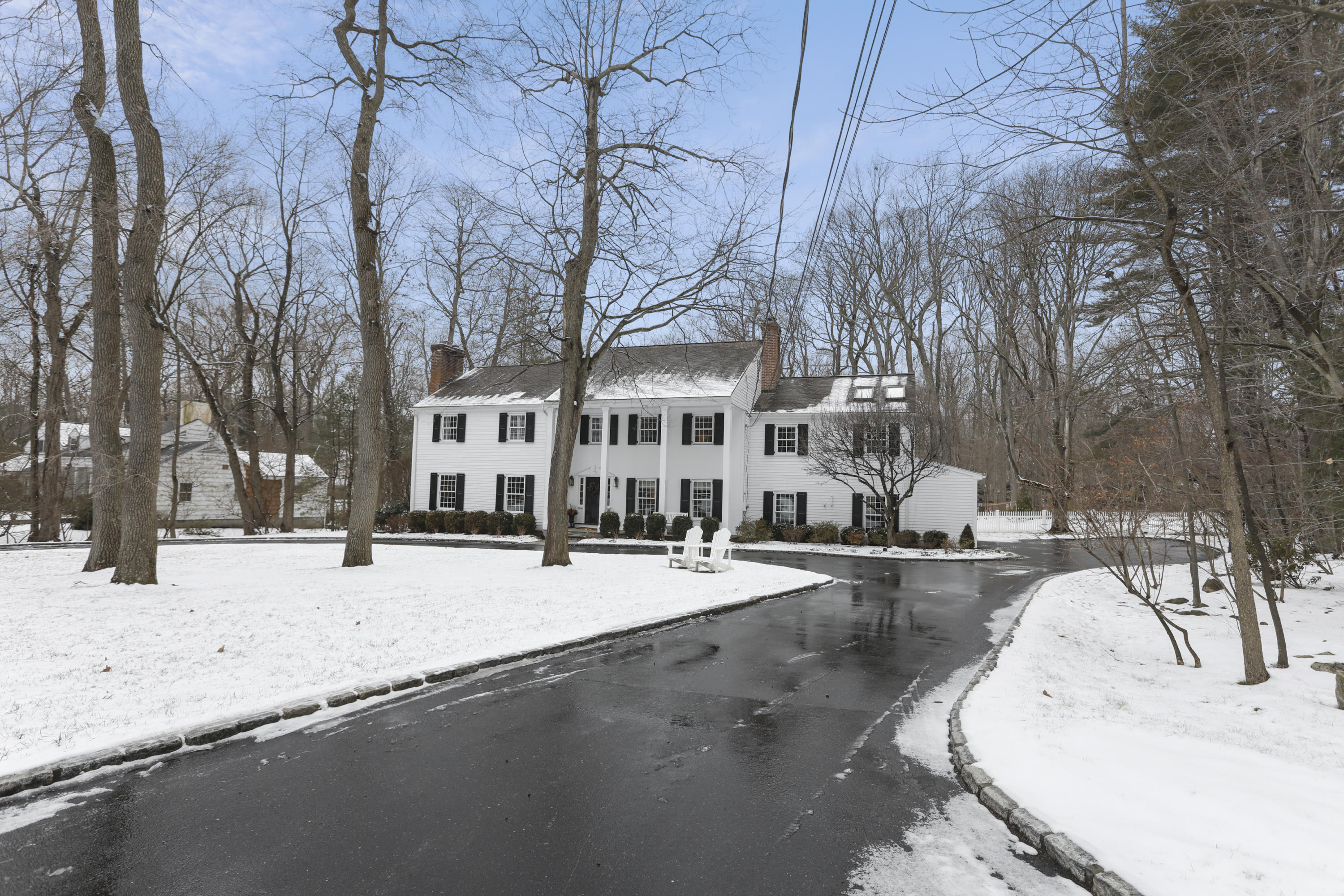 27 Deepwood Road Darien, CT 06820 - Photo 4 of 48 a view of a house with snow on the road