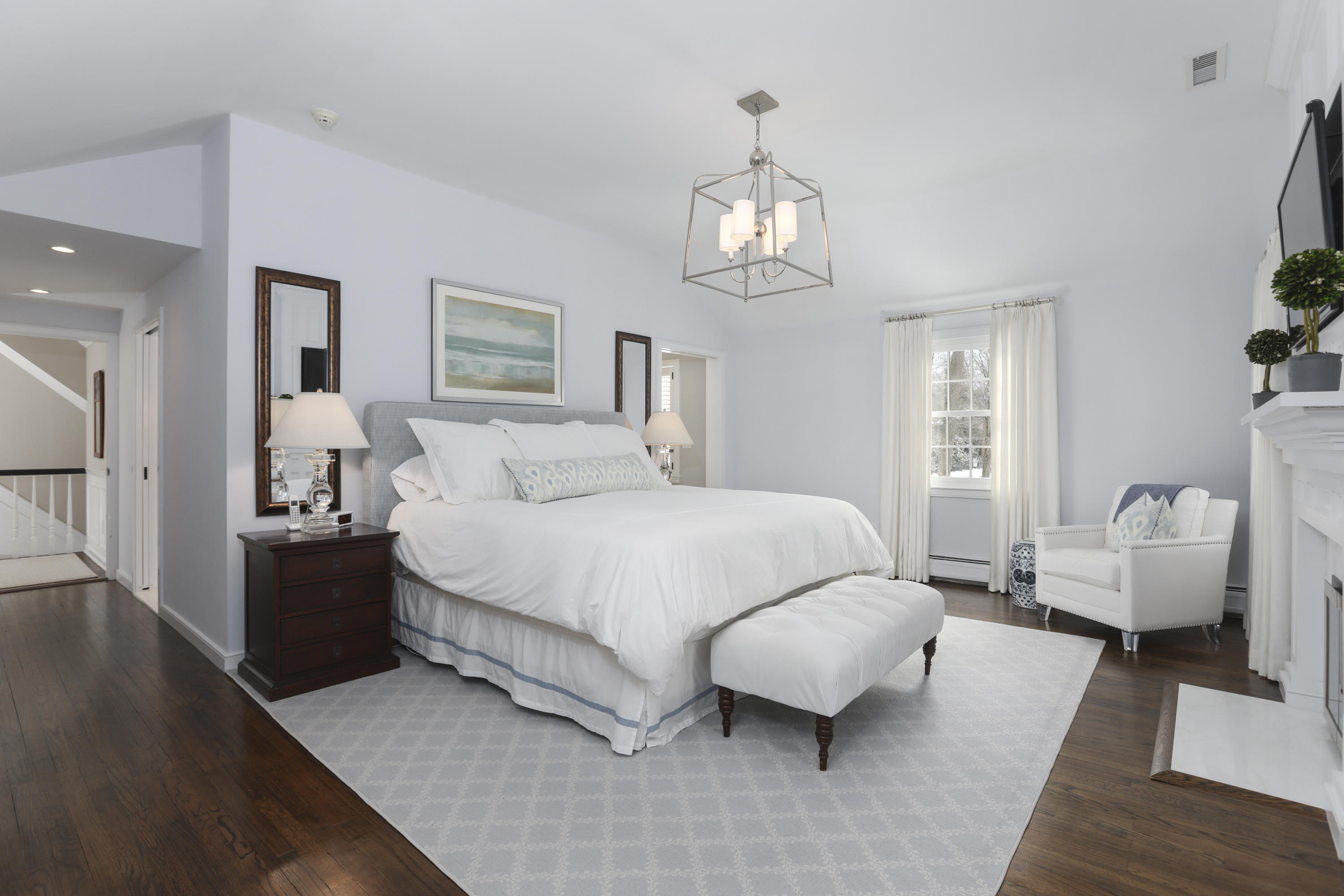 27 Deepwood Road Darien, CT 06820 - Photo 31 of 48 a spacious bedroom with a bed and wooden floor