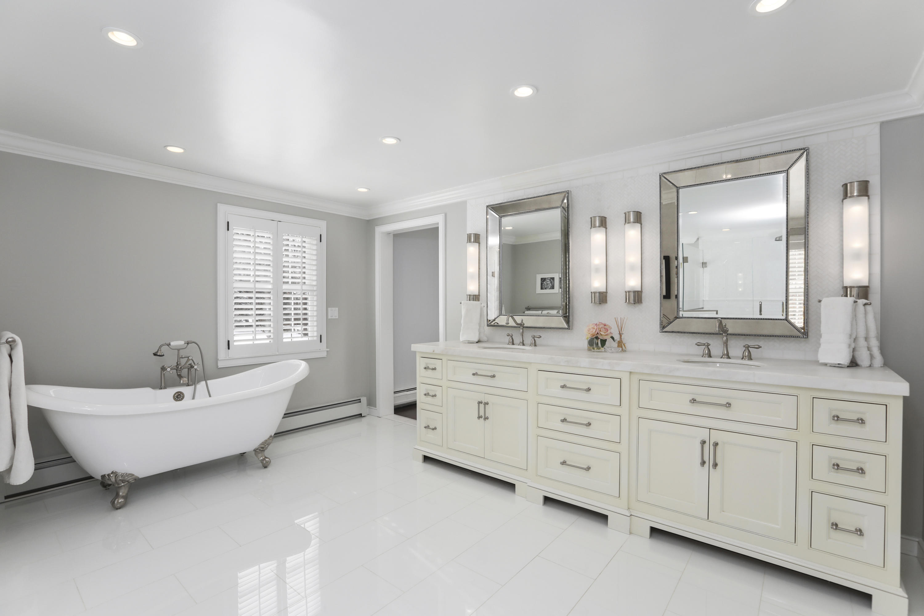 27 Deepwood Road Darien, CT 06820 - Photo 34 of 48 a spacious bathroom with double vanity sink a mirror a window and a bathtub