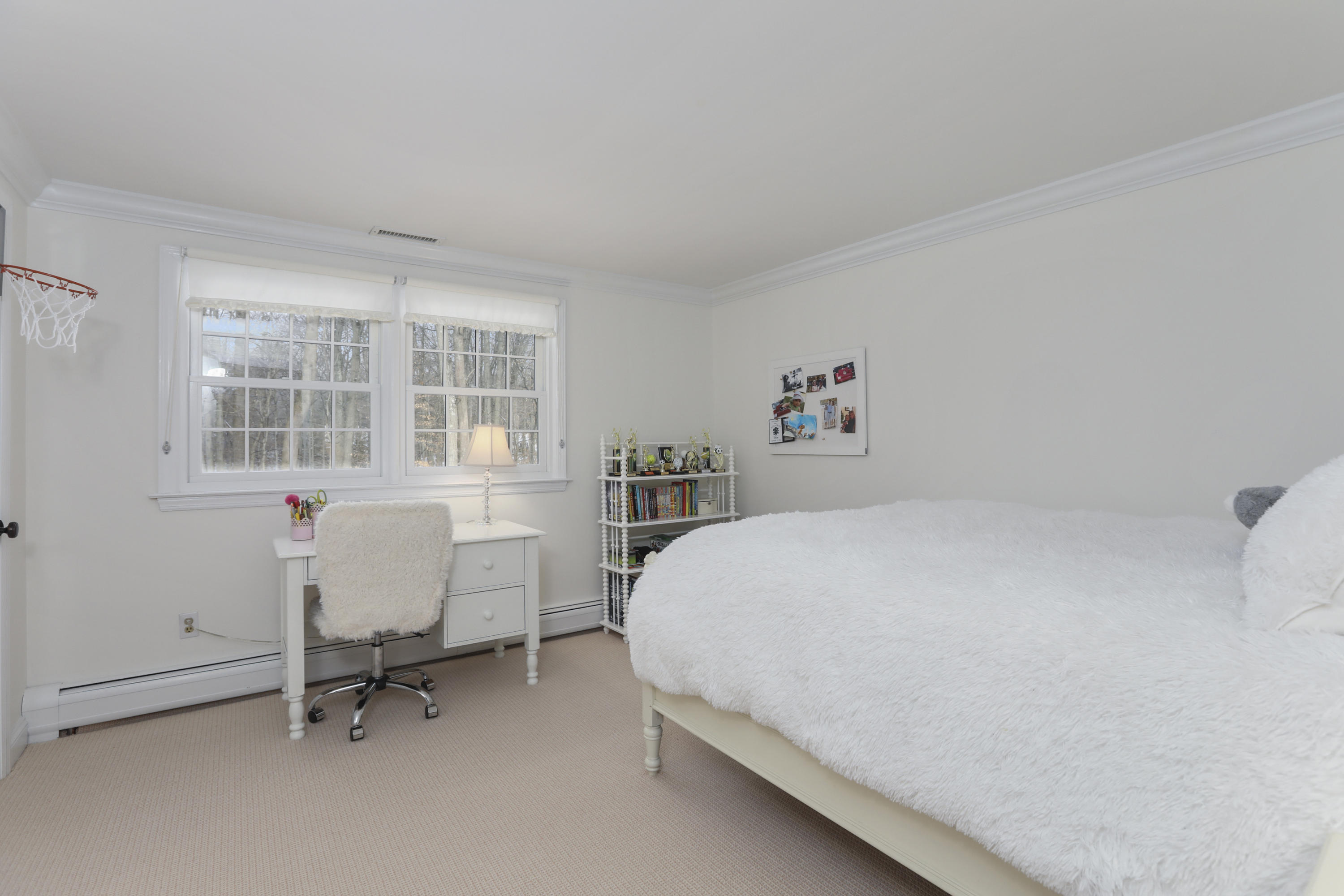 27 Deepwood Road Darien, CT 06820 - Photo 36 of 48 a bedroom with a bed a table and windows