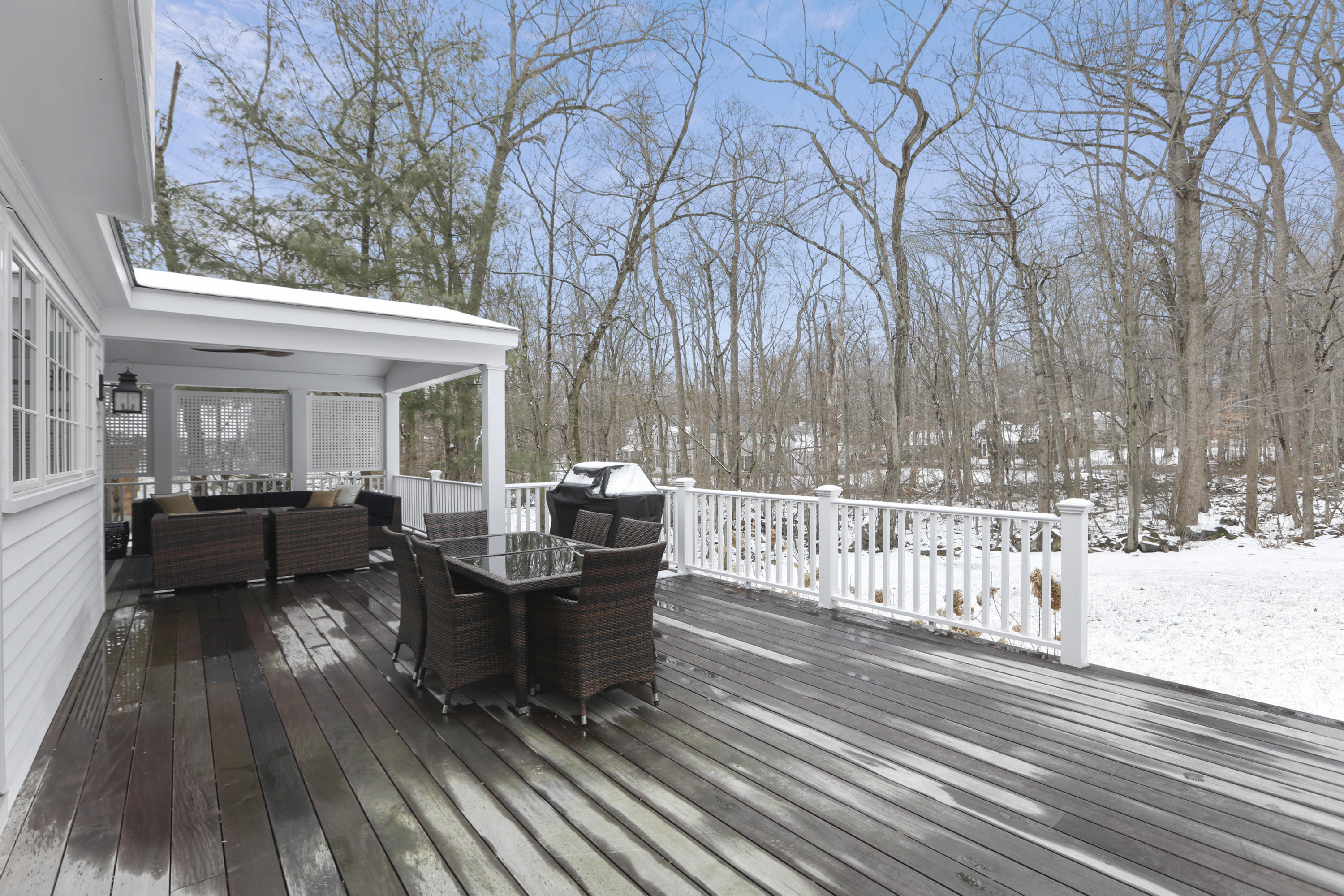 27 Deepwood Road Darien, CT 06820 - Photo 41 of 48 a view of a patio with table and chairs with wooden floor and fence