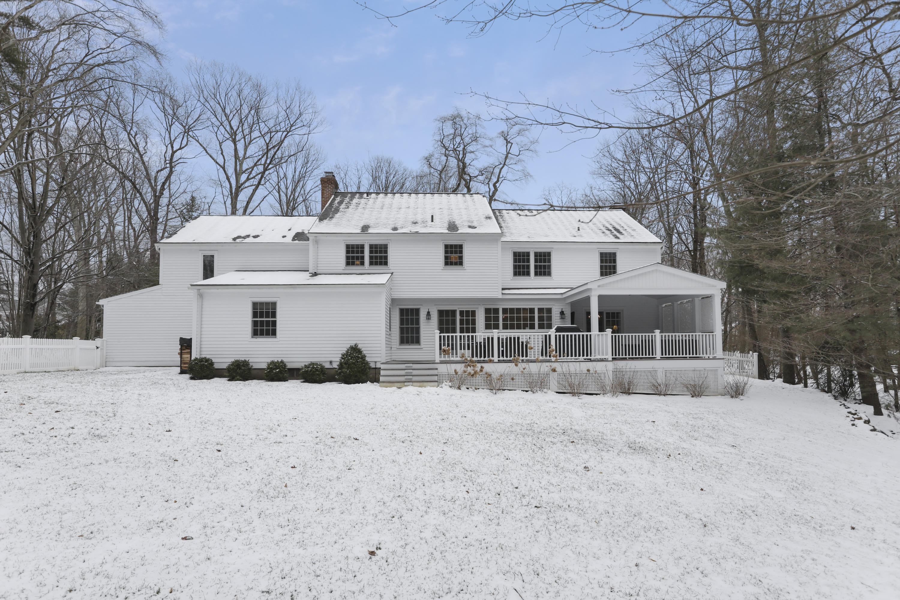 27 Deepwood Road Darien, CT 06820 - Photo 42 of 48 a view of a white house with a snow in the yard