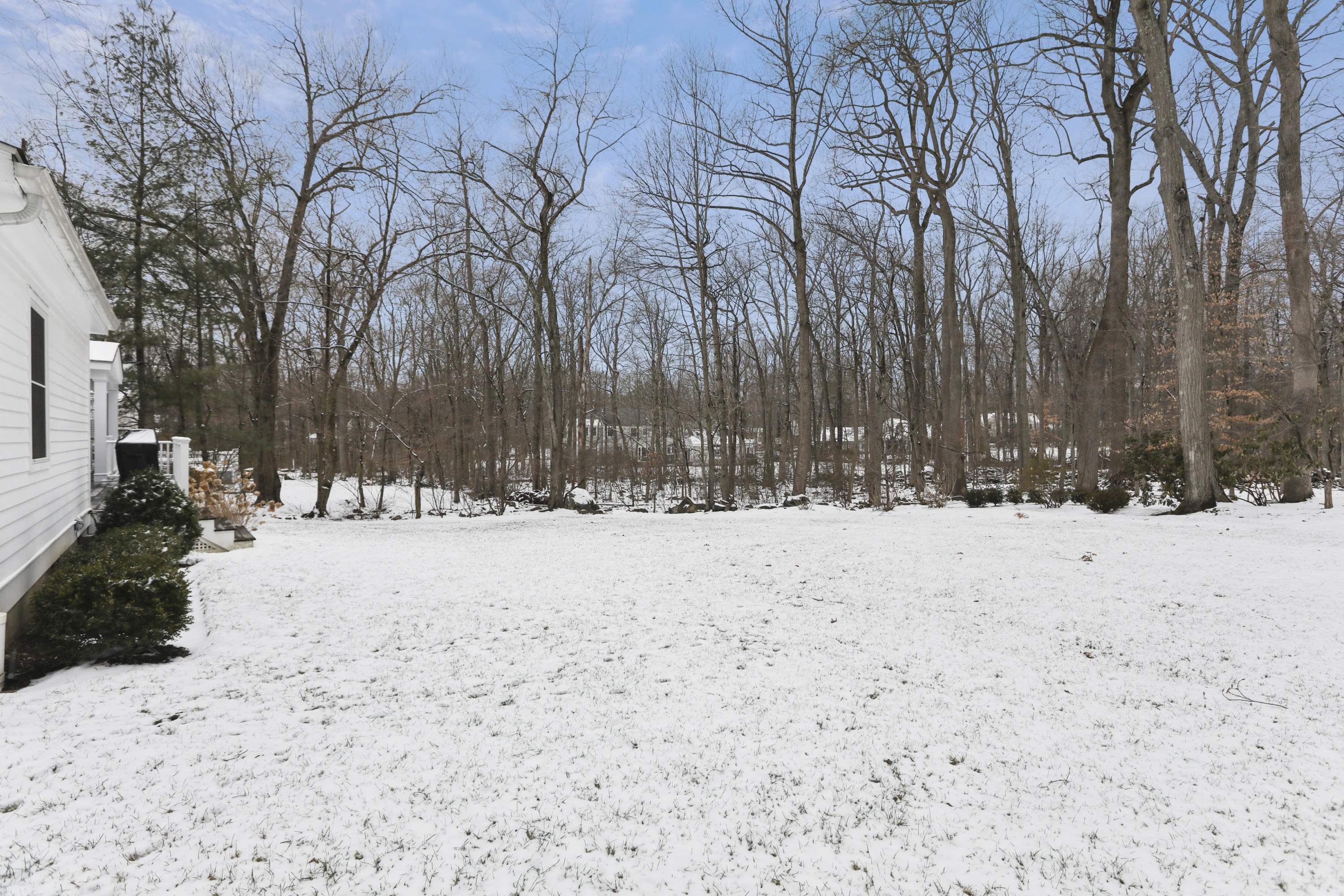 27 Deepwood Road Darien, CT 06820 - Photo 45 of 48 a street view covered with snow