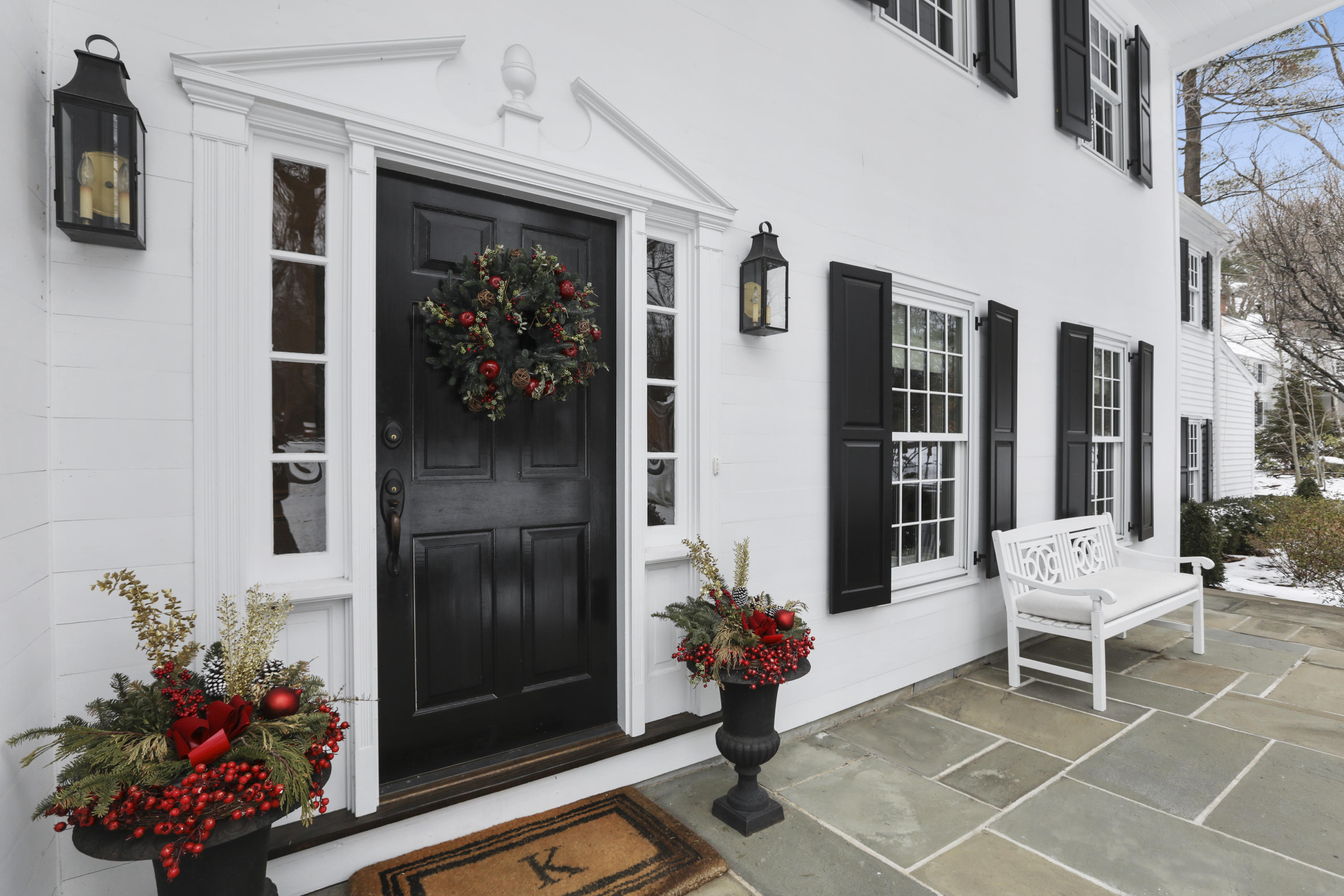 27 Deepwood Road Darien, CT 06820 - Photo 7 of 48 a porch with a bench and a potted plant