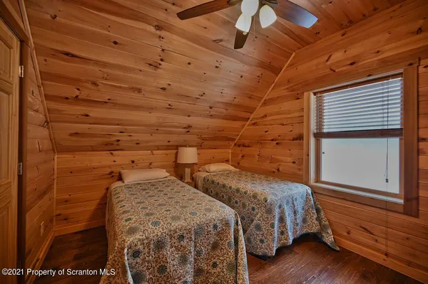 a view of a balcony with wooden floor and a bathroom