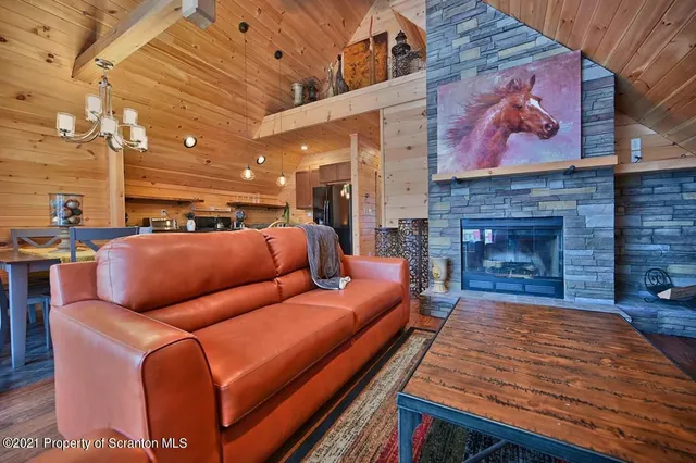a dining room with furniture and a floor to ceiling window