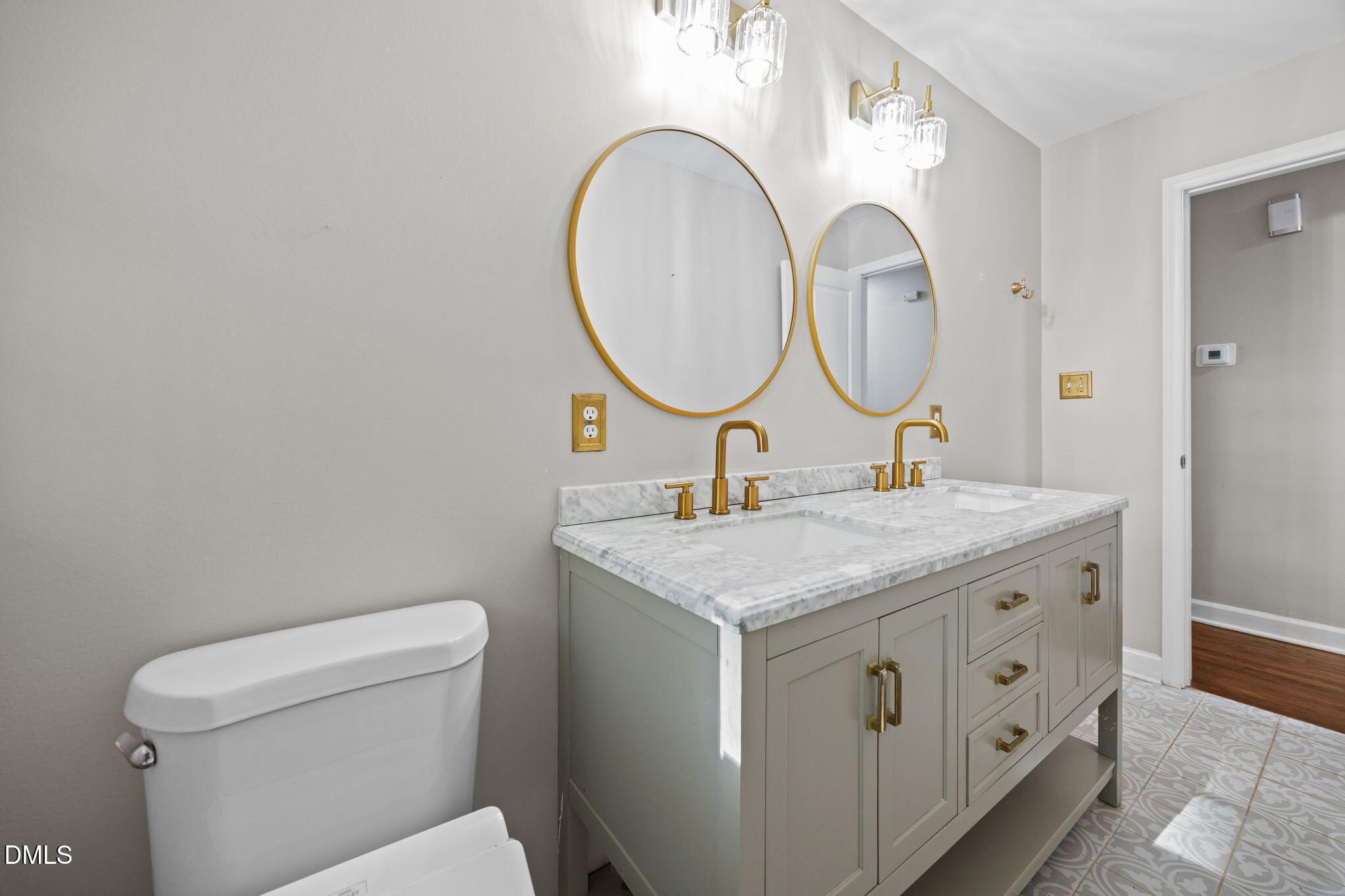 2950 Glenridge Drive Raleigh, NC 27604 - Photo 29 of 53 a bathroom with a granite countertop toilet sink and a mirror