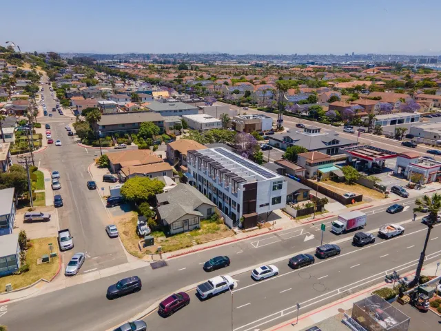 an aerial view of residential houses with outdoor space