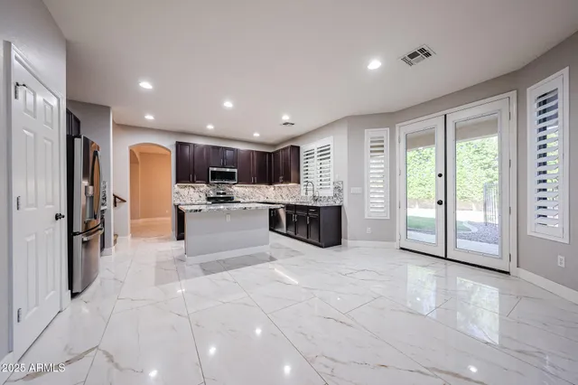 a bathroom with a double vanity sink toilet mirror and bathtub