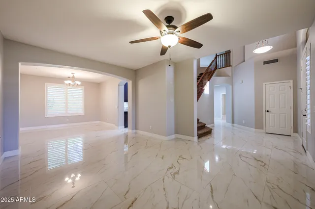 a view of empty room with a fireplace and windows