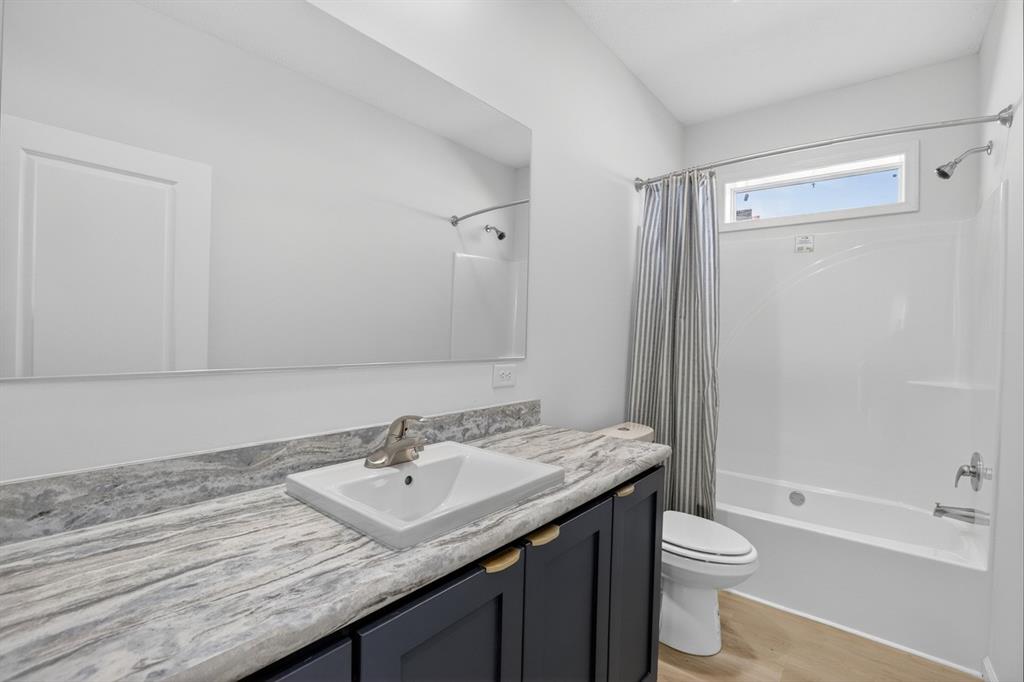 204 Doss Lane Moody, TX 76557 - Photo 14 of 19 a bathroom with a granite countertop sink toilet and shower