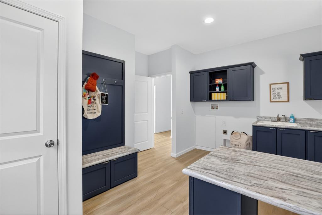 204 Doss Lane Moody, TX 76557 - Photo 17 of 19 a hall with kitchen island white cabinets and stainless steel appliances
