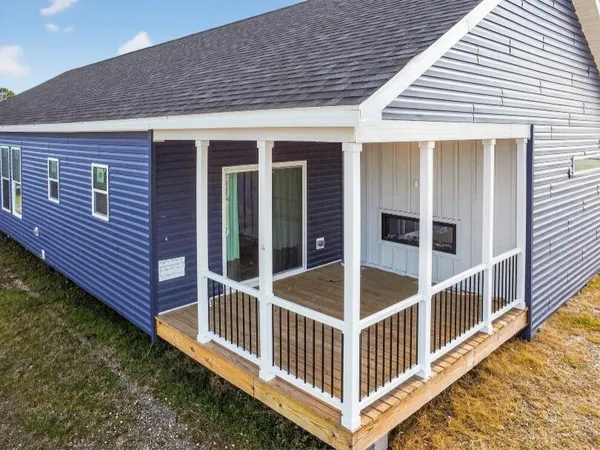 a view of a house with yard and deck