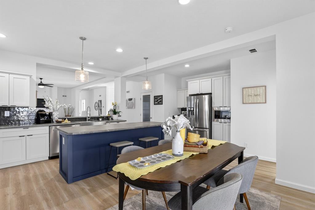 204 Doss Lane Moody, TX 76557 - Photo 5 of 19 a kitchen with a dining table cabinets and stainless steel appliances